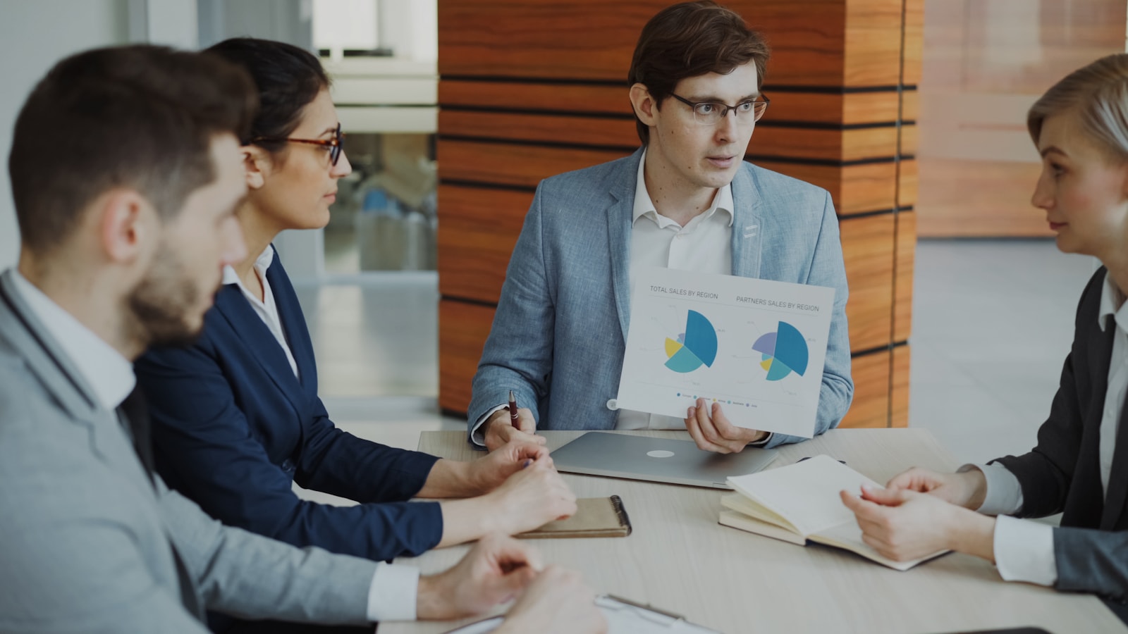 Business team discussing printed charts during a meeting